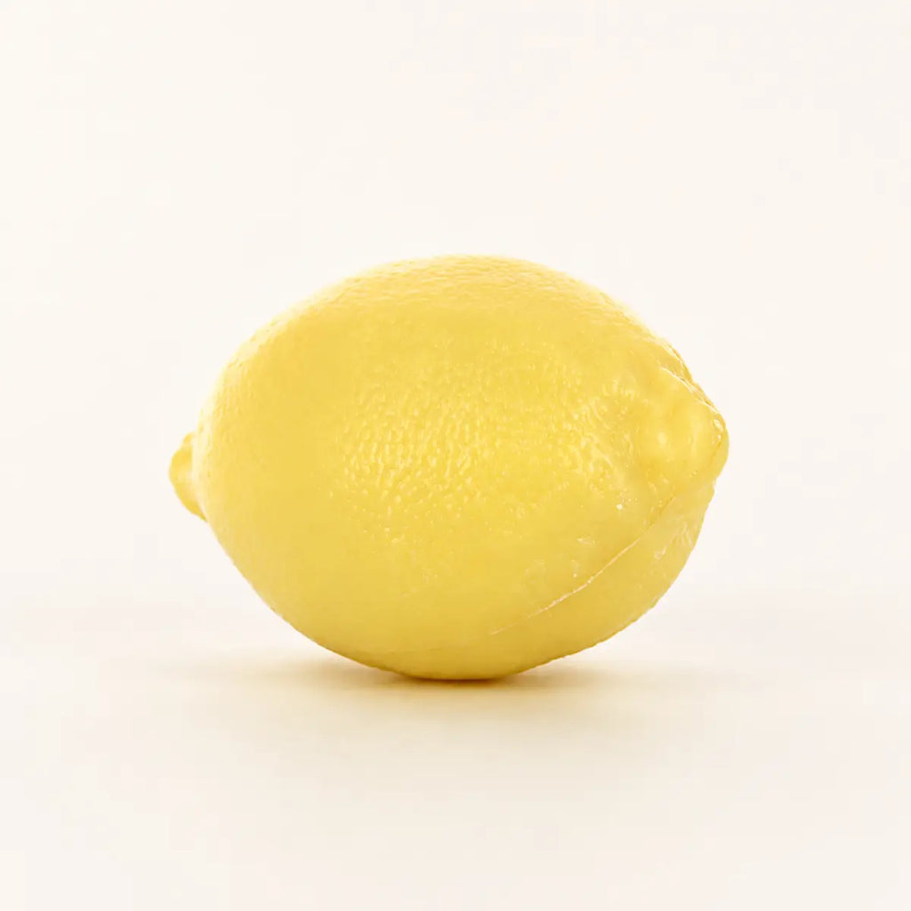 Yellow lemon-shaped 125g French soap with realistic citrus texture