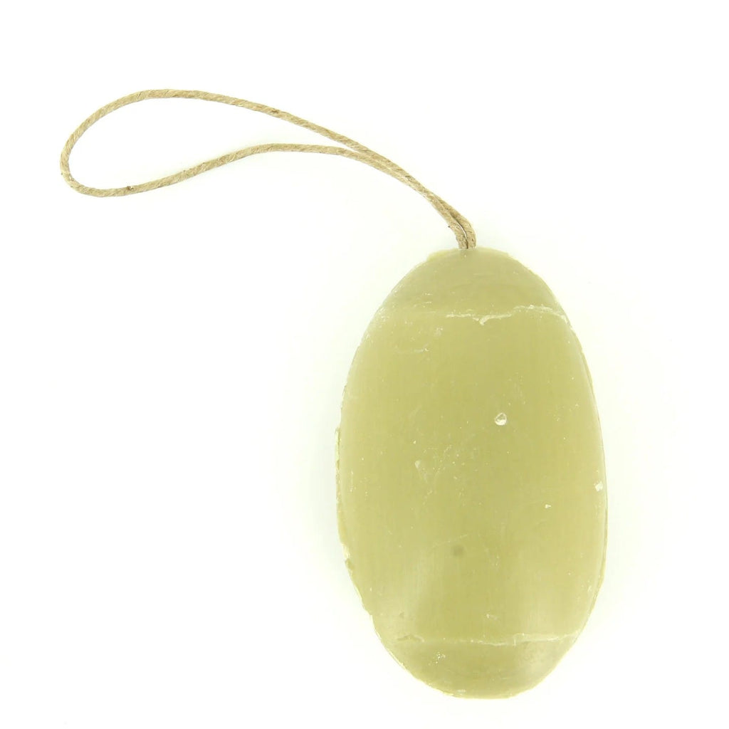 Yellow-green soap bar with a rope on a white background