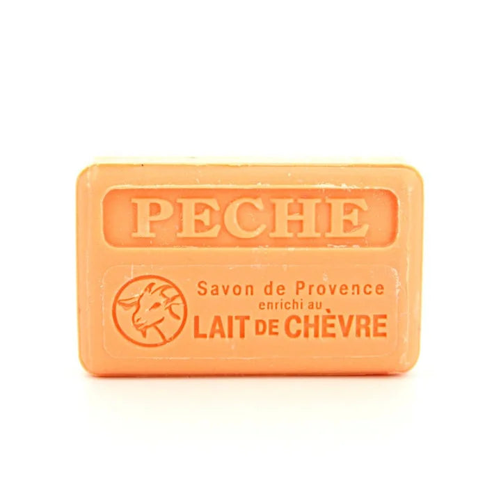 An orange rectangular bar of soap with embossed text reading 'PECHE' and 'Savon de Provence enrichi au LAIT DE CHÂVRE' on a white background.