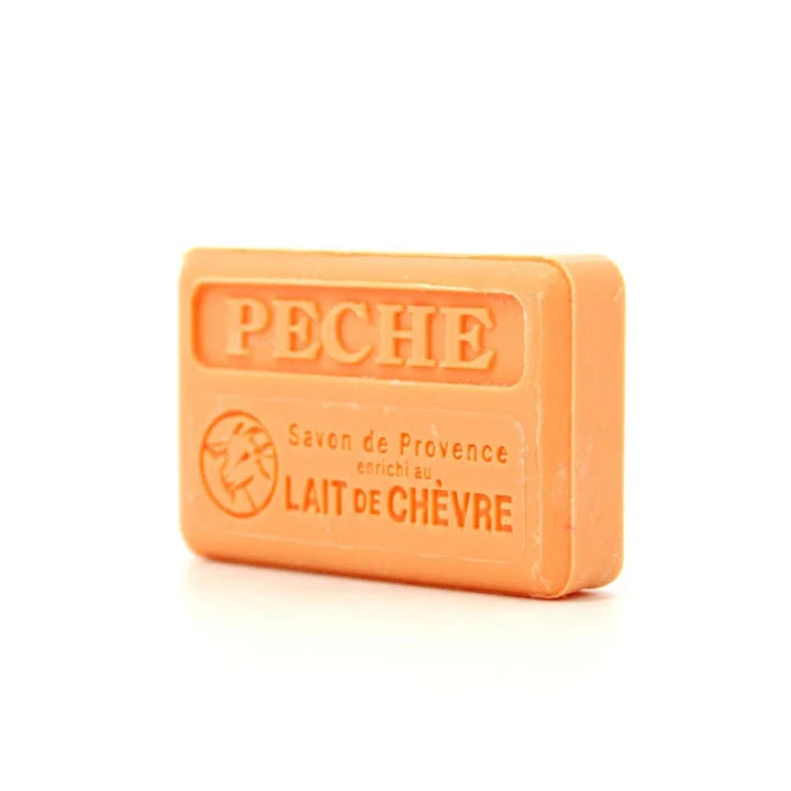 An orange rectangular bar of soap with embossed text reading 'PECHE' and smaller text 'Savon de Provence enrichi au LAIT DE CHEVRE' on a white background.