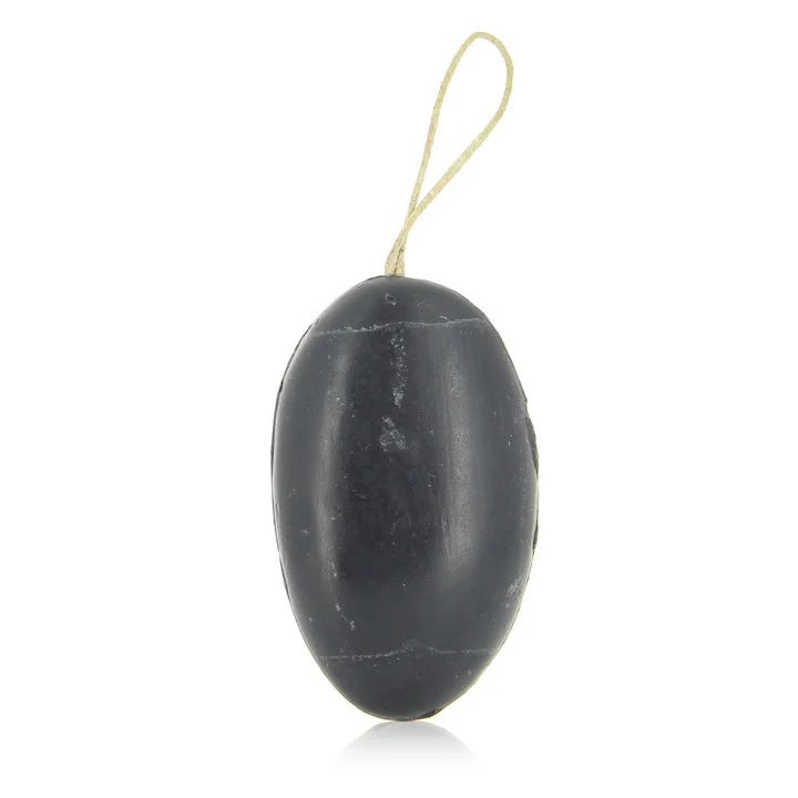 A black oval-shaped French soap with a small looped string at the top, shown against a plain white background.