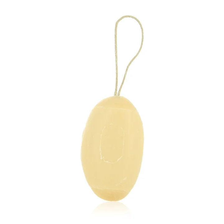 A pale yellow oval-shaped soap bar with a loop string at the top, shown on a plain white background.