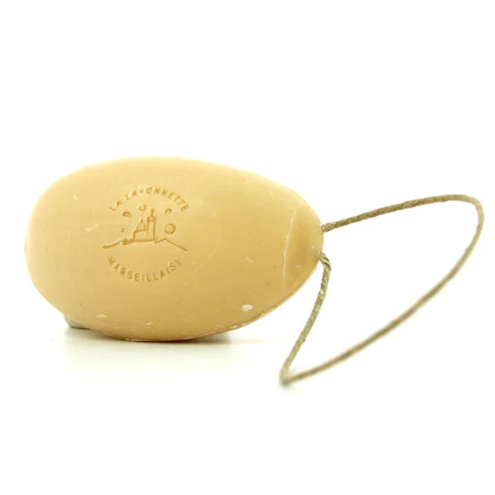 A natural beige soap bar with a loop, embossed with the brand shown on a white background.