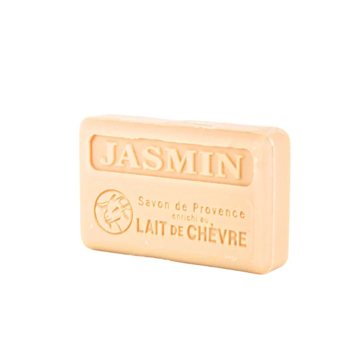 A rectangular bar of Jasmin Savon de Provence lait de chevre soap in a warm peach-beige color, featuring embossed branding and text on a plain white background.