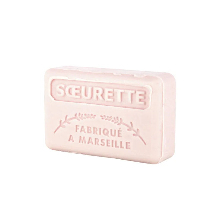 A pale pink rectangular bar of soap embossed with the brand name 'SOEURETTE' and 'FABRIQUÉ A MARSEILLE', shown on a plain white background.
